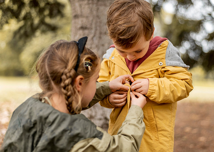 girl helping boy blog